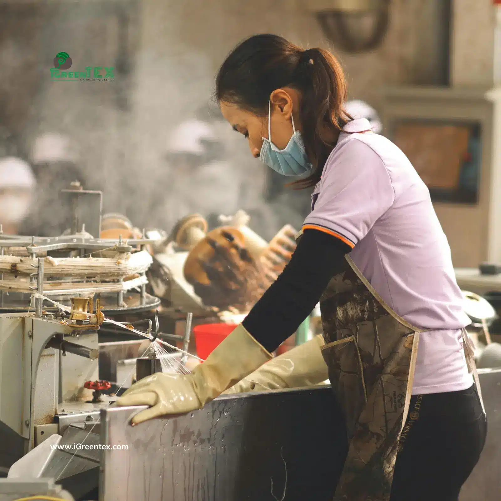 A large-scale textile mill featuring advanced weaving and spinning machinery. This image explains what is a textile manufacturer by showing the initial stage of fabric production before the materials are sent to iGreen Tex Vietnam for garment assembly.