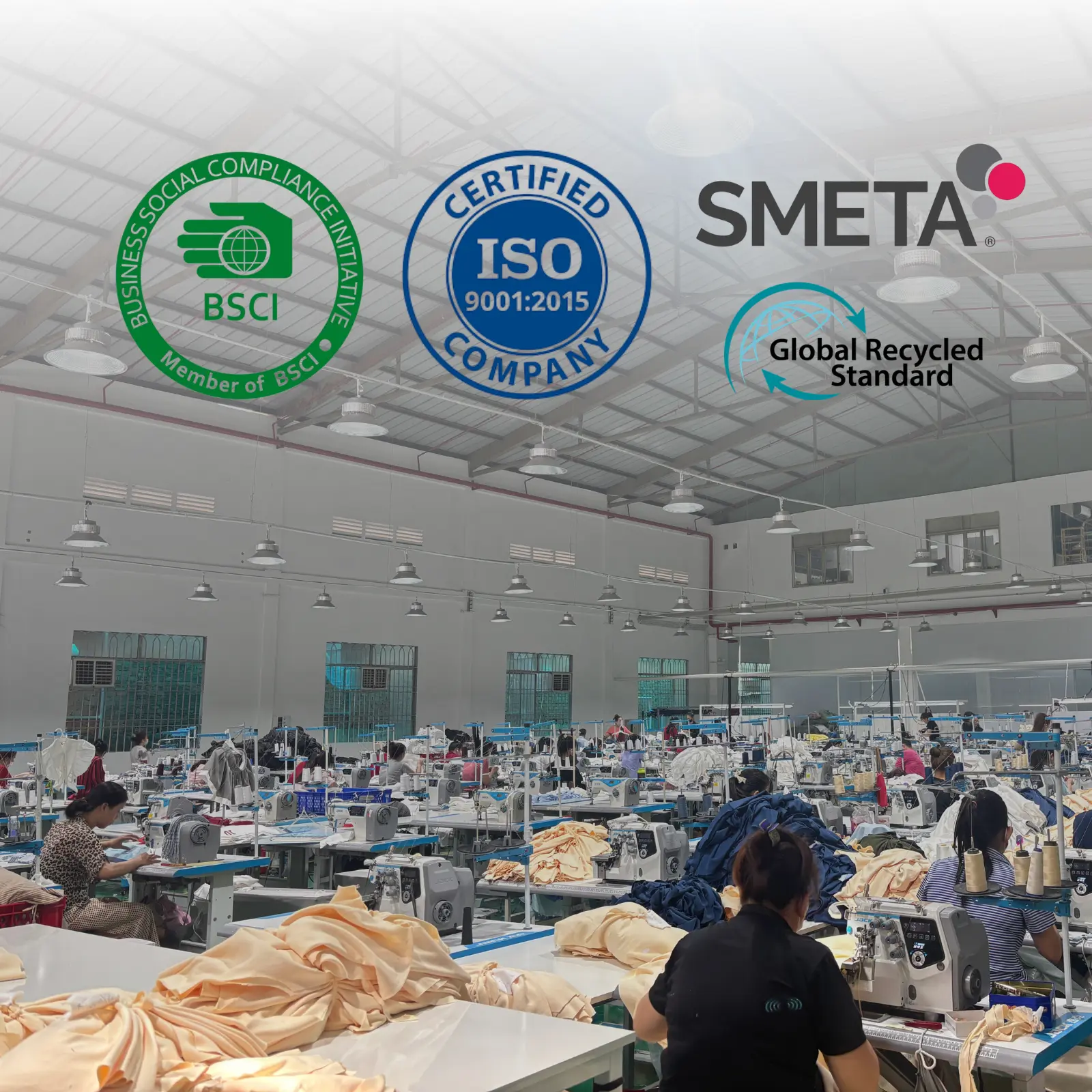 A wide photograph of the active sewing lines inside iGreen Tex Vietnam, a leading apparel manufacturer. Four prominent logos are integrated into the factory environment: SMETA, ISO 9001:2015, BSCI, and GRS. This visual proof assists global sourcing teams in verifying this certified garment factory vietnam partner for ethical, quality, and sustainable production.