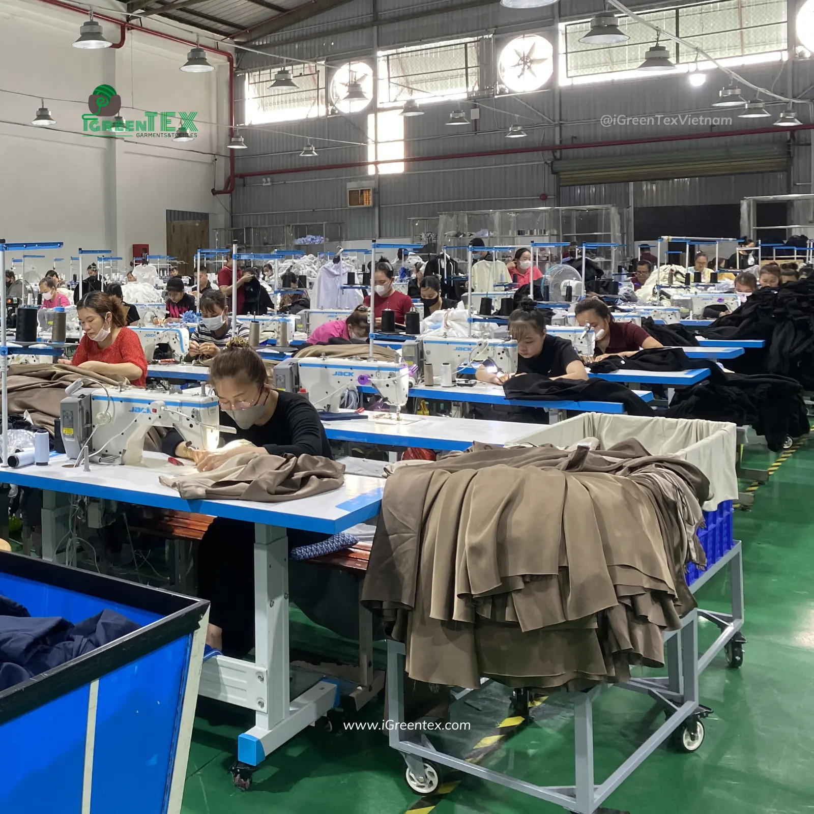 Custom brand labels being stitched onto apparel showing why manufacture clothing in Vietnam.