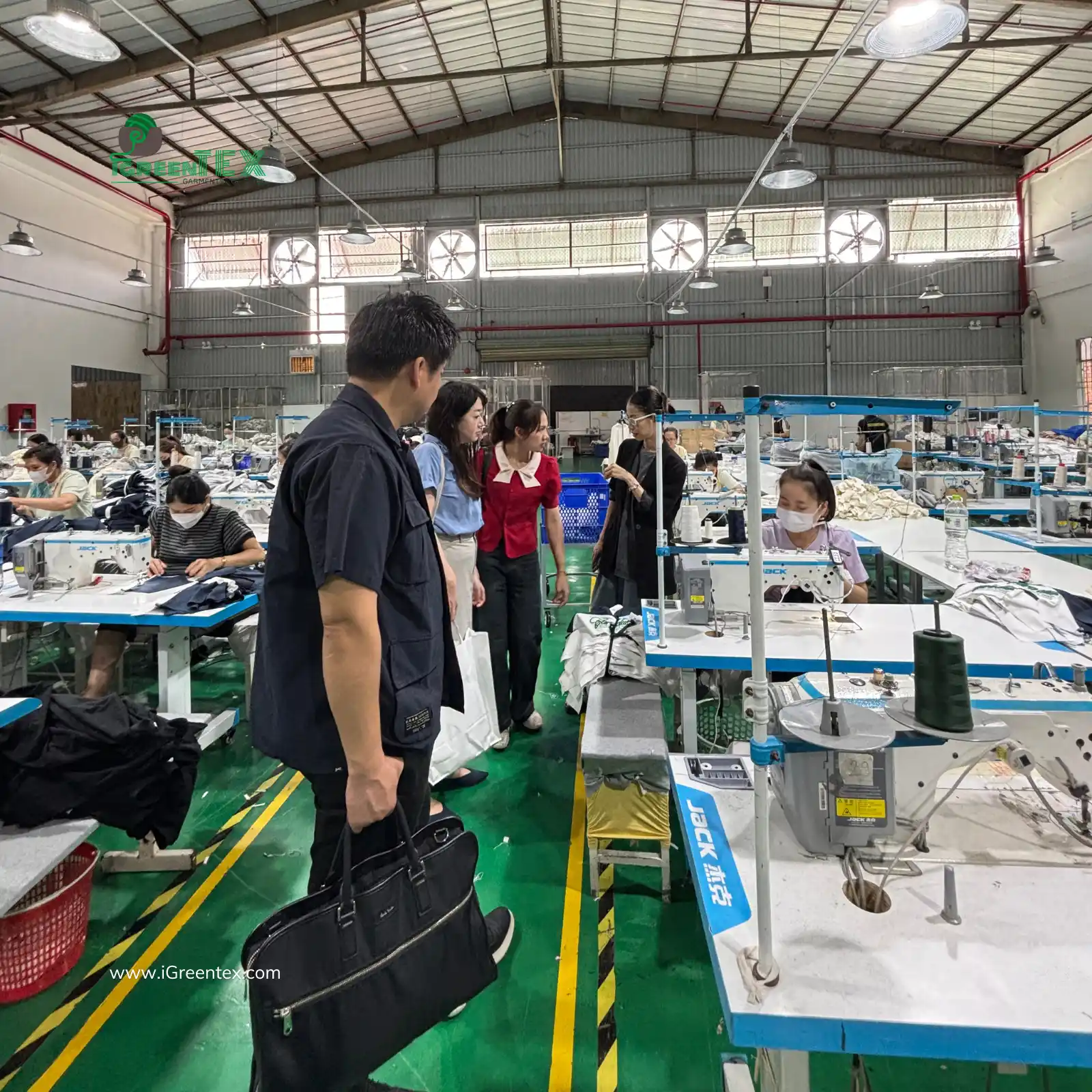 A first-time buyer reviewing a simple checklist during a clothing factory audit at iGreen Tex Vietnam.